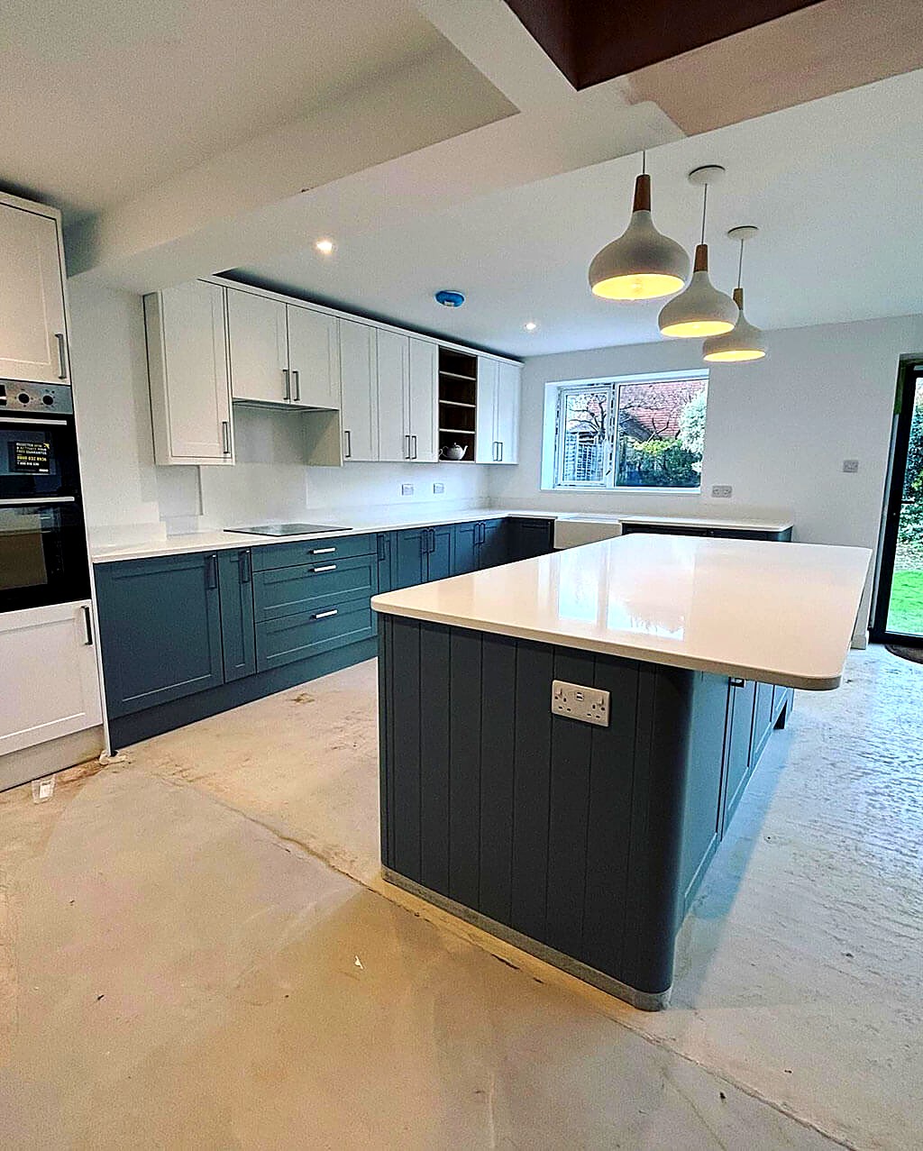 Shaker kitchen with a large island, quartz worktop and pendant lighting